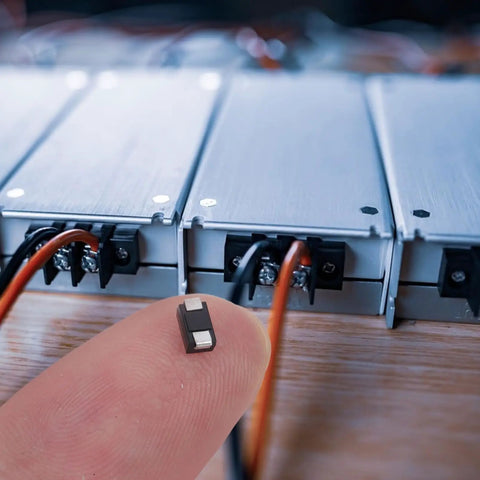 Close-up of a Top Shelf Rectifier Diode from the 100 Piece Assortment Kit for AC to DC conversion on a fingertip.