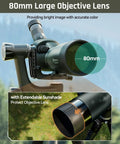 20 To 60x80 ED Spotting Scope With HD Optics Dual Focusing Fog Proof Waterproof Detachable Eyepieces And Smartphone Adapter For Hunting Target Shooting And Birding with 80mm large objective lens mounted on tripod outdoors.