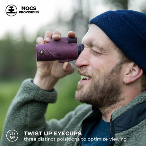 Ultra Portable 10x32 Waterproof Monocular For Bird Watching And Birding Adventures With Fully Coated Optics Bak4 Prism Oversized Focus Wheel And A 333 Ft Field Of View At 1000 Yards Lightweight 8 Oz. man using purple monocular with twist-up eyecups outdoors