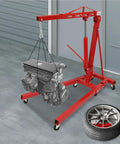 Heavy Duty Carbon Steel Engine Hoist With Smooth Hydraulic Lifting System And Foldable Stand Frame For No Drama Backyard Mechanic Garage Tool Optimization lifting an engine in a garage.