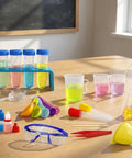 Hands On Lab Science Kit For Kids with 33 pieces of beakers, test tubes, goggles, and colorful tools on a classroom table.