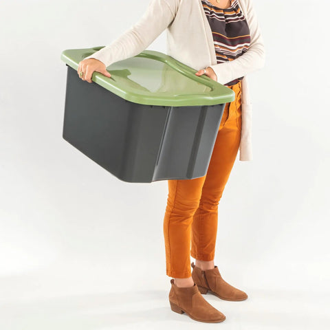 Heavy Duty 17.5 Gallon Plastic Storage Bin With Clear Lid And Full Length Through Wall Handles Gray Opaque Base held by a person.
