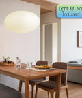 Oval Crepe Paper Lanterns 22 Inch Two Pack For Indoor Ceiling Decor hanging above dining table in modern room.