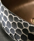 Close-up of USZWBY Bathroom Vessel Sink 16.9 X 5.9 Inch Bathroom Sink Ceramic Vessel Sink with black and beige pattern.