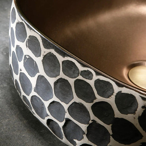 Close-up of USZWBY Bathroom Vessel Sink 16.9 X 5.9 Inch Bathroom Sink Ceramic Vessel Sink with black and beige pattern.