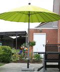Ultra Sturdy Heavy Duty Granite Umbrella Stand For Outdoor Tables And DIY Projects Adjustable Post Clamp Fits One Point Three To Two Inches Stone Base Holder For Cement And Granite Boards in garden with green umbrella