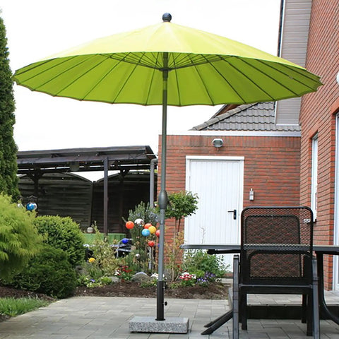 Ultra Sturdy Heavy Duty Granite Umbrella Stand For Outdoor Tables And DIY Projects Adjustable Post Clamp Fits One Point Three To Two Inches Stone Base Holder For Cement And Granite Boards in garden with green umbrella