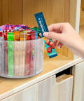 Person selecting a packet from a 360 Degree Rotating Drink Packet Organizer Lazy Susan For Powdered Drink Mixes And Condiments.