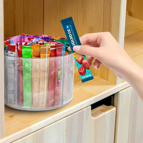 Person selecting a packet from a 360 Degree Rotating Drink Packet Organizer Lazy Susan For Powdered Drink Mixes And Condiments.