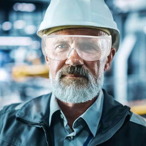 Close-up of a man wearing Six Pair Safety Glasses With Ventilated Louvered Frames And Wraparound Side Shields For Lab Projects And Shop Work Impact Resistive Clear Lenses.