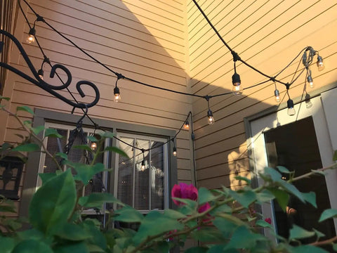 Outdoor patio with 11W Outdoor S14 Incandescent Replacement Bulbs 120V E26 Base 16 Pack for cozy backyard vibes and festive ambience