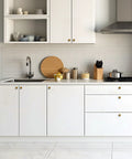 Modern kitchen with white cabinets fitted with 30 Pack Antique Brass Cabinet Knobs 1-1/4 Inch Diameter Round Solid Zinc Alloy Drawer Pulls.