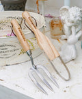 Versatile Weeding Fork Hand Tool With A 12 Inch Wood Handle And 3 Pointed Tines for gardening on white surface