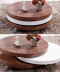 Round wooden coffee table with a rotating white top section for adjustable display or storage.