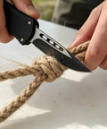 Everyday Carry Folding Knife For Outdoors With AUS10 Steel Blade cutting rope, showcases rust resistance and sharpness