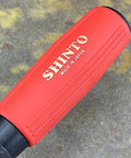 Close-up of the heavy duty rubber grip on a Japanese Rasp And Sanding Block Quick Swap Blades tool, showing logo.