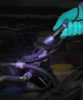LEAKFINDER LF021 leak detection kit with dye injector and UV light, held by gloved hand near engine hoses