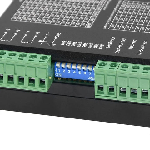 Close-up of Knockout CNC Digital Microstep Driver DM542 connectors and switch settings for stepper motor controller.
