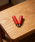 Durable 2-Piece M10x80 Revolving Crank Handle For Lathe And Milling Machines with red bakelite grips on wooden table.