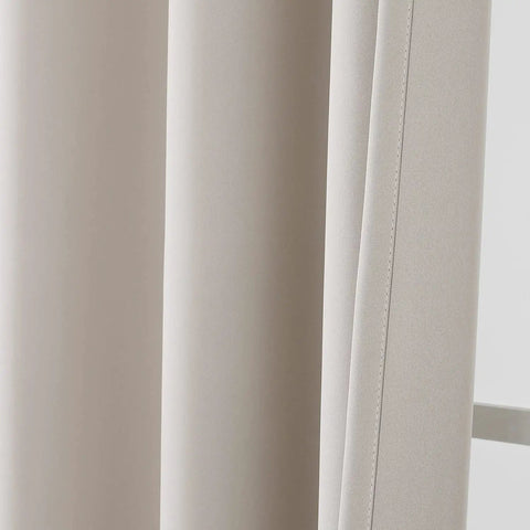Close-up of light beige fire retardant blackout curtain with grommet top, NFPA 701 certified, ideal for dorms and living rooms.