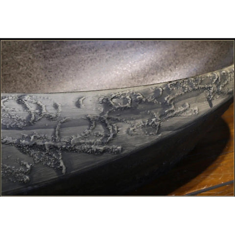 Close-up of USZWBY Bathroom Sink Creativity Ceramic Vessel Sink with distinctive stone texture and unique shape.