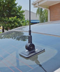 Glass-mounted Pretuned Dual-Band Ham Radio Antenna Kit 144 148 MHz VHF And 440 450 MHz UHF with black base on car window.