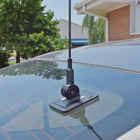 Glass-mounted Pretuned Dual-Band Ham Radio Antenna Kit 144 148 MHz VHF And 440 450 MHz UHF with black base on car window.