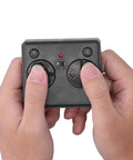 Hands holding remote for RC Submarine Remote Control Toy for Kids 2.4G Six Channel Model With Water Activated Safety System