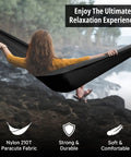 Woman relaxing in Durable Nylon Camping Hammock For Outdoors, set up by a river, enjoying nature, made from Nylon 210T fabric.
