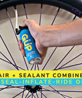 Hand using Quick Fix Tire Sealant And Inflator 2 Pack For Tubeless And Tubed Tires with bike wheel and valve adapter visible