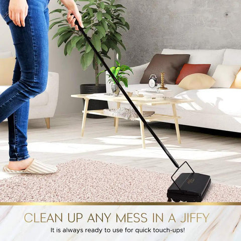 Electrostatic Carpet And Floor Sweeper Boasts A Nine Inch Cleaning Path For Tile And Rug, in use on a rug, matte black design.