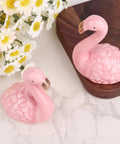 Totally Vibes Super Sweet Pink Flamingo Ceramic Toilet Bolt Covers Sets Off That Nice Vibe In Any Bathroom Super Easy Install Waterproof Flange Caps For A Fast Home Glow Up Two Pack displayed with flowers.