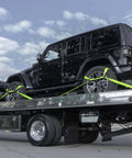 Black SUV secured on flatbed with Eight Point Vehicle Tie Down Kit With Snap Hook Ends And Chain Tail On Ratchet Ends Set Of Four