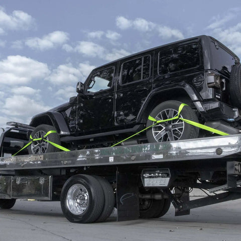 Black SUV secured on flatbed with Eight Point Vehicle Tie Down Kit With Snap Hook Ends And Chain Tail On Ratchet Ends Set Of Four