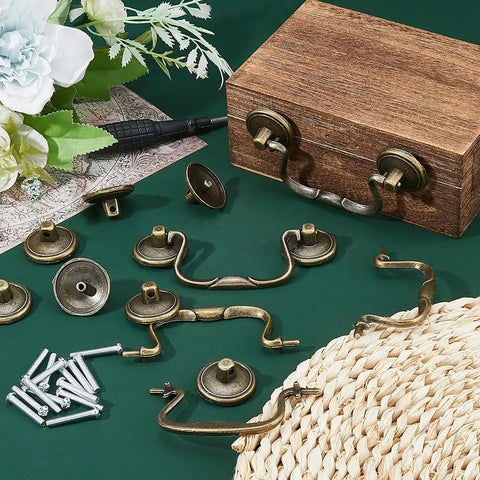 Old School Vintage Bail Pull Handles Set Of 10 In Antique Bronze For Cabinet Drawer Pulls And Cupboard Hardware Thirty Four By Ninety Two By Eight Point Five Millimeters Alloy Drop Drawer Pulls For Kitchen And Bedroom displayed with screws and wooden box on green surface.