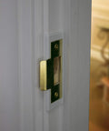 Close-up of brass finish Mixed 2 Pack Door Latch Repair Kit installed on door frame, showing slim profile and 1/8 inch clearance.