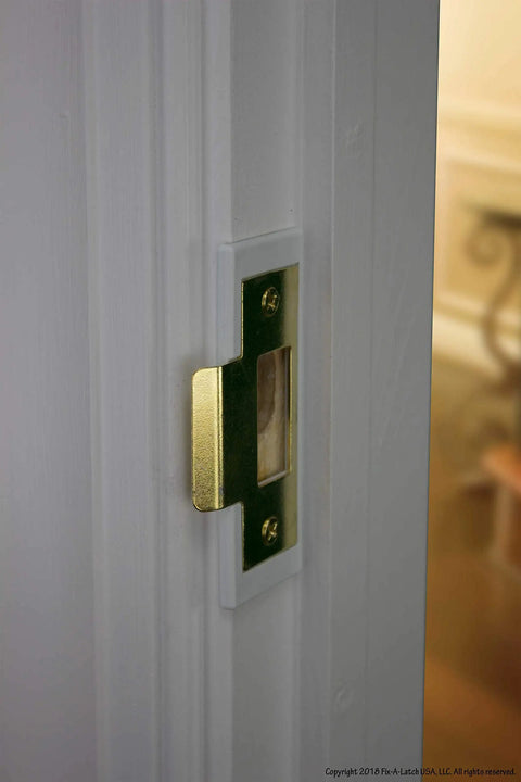 Close-up of brass finish Mixed 2 Pack Door Latch Repair Kit installed on door frame, showing slim profile and 1/8 inch clearance.