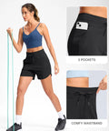 Woman wearing Women's 5 Inch Athletic Running Shorts With Quick-Dry Stretch, High Waist, 3 Pockets, demonstrating stretch with resistance band