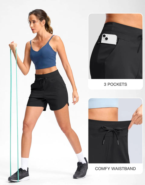 Woman wearing Women's 5 Inch Athletic Running Shorts With Quick-Dry Stretch, High Waist, 3 Pockets, demonstrating stretch with resistance band