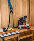 Workshop setup with 4 Inch To 2 Point 5 Inch Y Junction Dust Hose Splitter For Dust Collection Systems, attached to tools on a wooden workbench.
