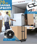 JMFOLD folding hand truck dolly, black steel frame with 2 PVC wheels, standing by open moving truck loaded with boxes.