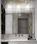 3 Light Gold Vanity Light Fixture For Bathroom With Crystal Accents Over Mirror, sleek design illuminating marble bathroom.