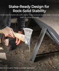 Person securing a portable 100 watt solar panel with kickstands for camping and off grid power stations using a stake