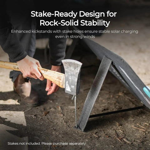 Person securing a portable 100 watt solar panel with kickstands for camping and off grid power stations using a stake
