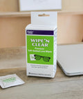 Front view of Flents Wipe N Clear lens wipes box and a single sachet, 20-count package with green front panel.
