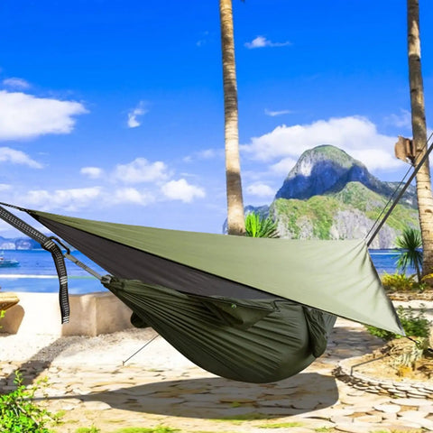 Durable Outdoor Camping Hammock With Mosquito Net And Rain Fly in scenic beach setting, green nylon material.