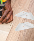 Person installing 12 Piece Triangle Steel Cabinet Corner Brackets 90 Degree Three Sided Fixed Design Shelf Supports for Wood Furniture.
