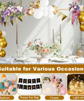 Badass Heavy Duty Over The Table Rod Stand For Balloons And Props With Secure Grip Clamps Adjustable 30 To 47 Inches High And 34 To 98 Inches Long Metallic Gold Arch Bar displayed with balloons and flowers for a festive event.