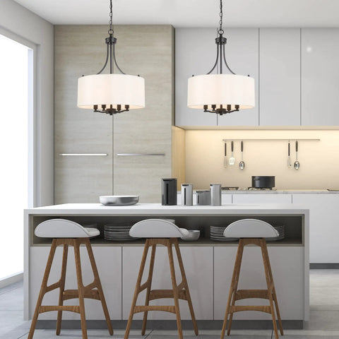 Kitchen with Totally Chic Modern Farmhouse Drum Chandelier with Linen Fabric Shades over island and stools, clean candle style look.