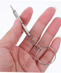 Mini screwdriver from the All In One Eyeglasses Repair Kit With Silicone Nose Pads, Mini Screwdrivers, Tweezers And Tiny Screws For Quick Eyewear Fixes And Comfortable Wear Great For Travel And Daily Repairs, Easy To Use At Home Or On The Go, held in a hand.